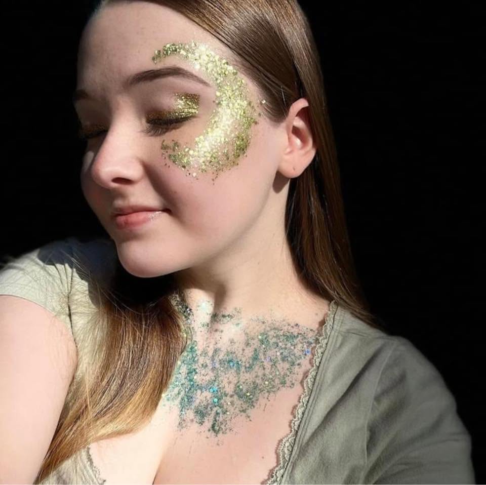 Gold glitter crescent moon on face with teal glitter neckline