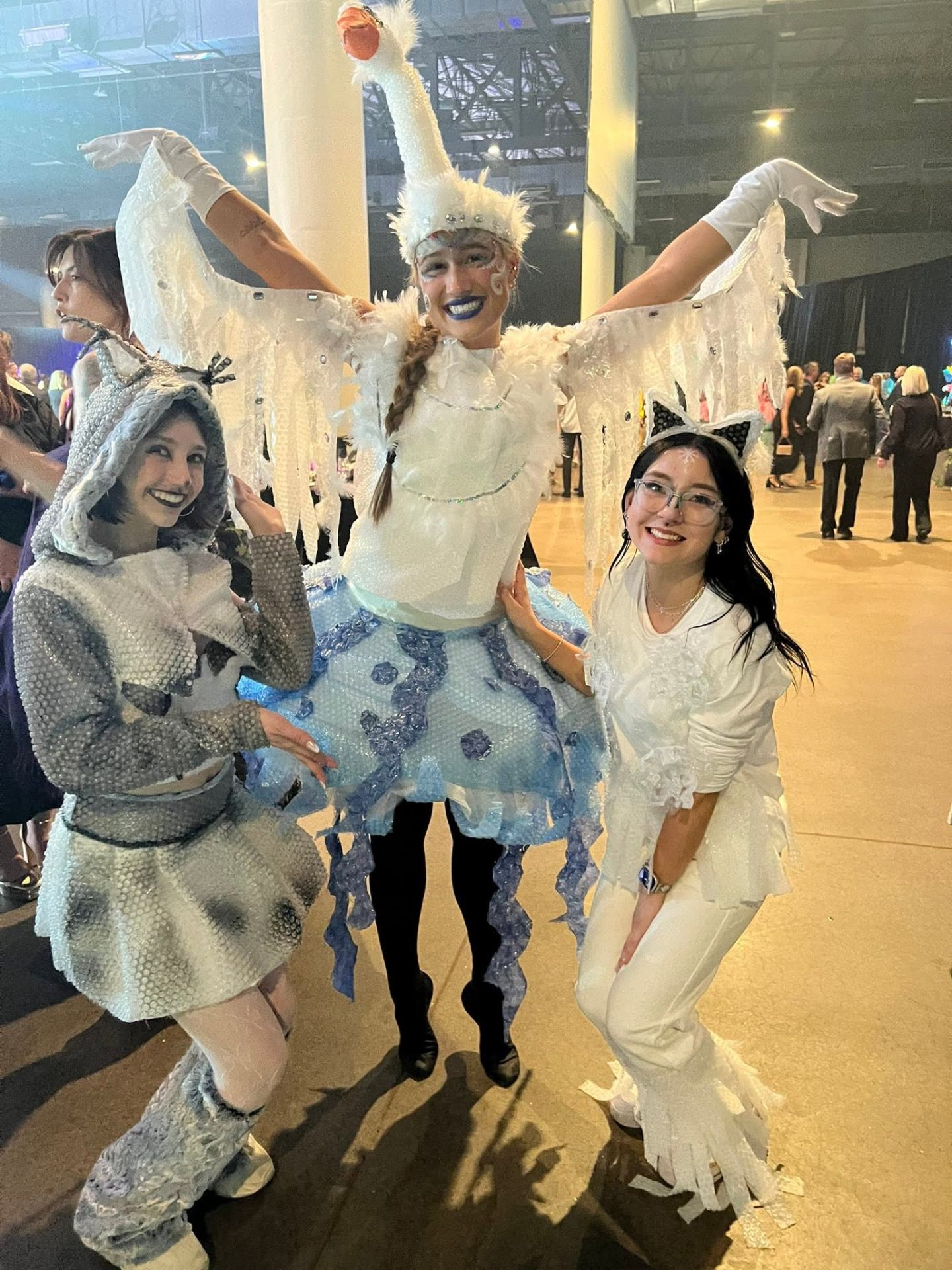 Full swan costume with feathered wings, headpiece and blue lipstick